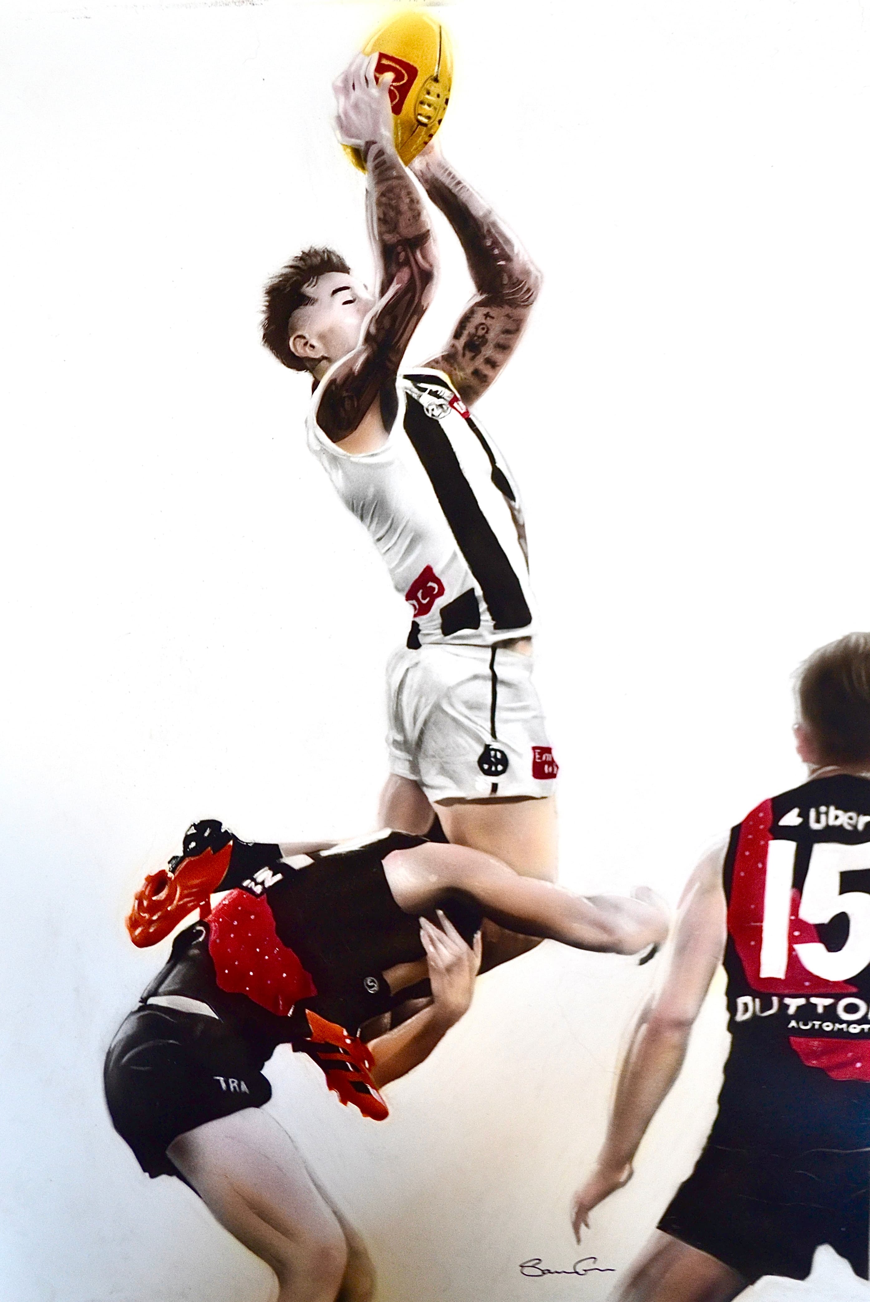 Tattooed footballer in black and white stripes leaps over an opponent to catch a ball.