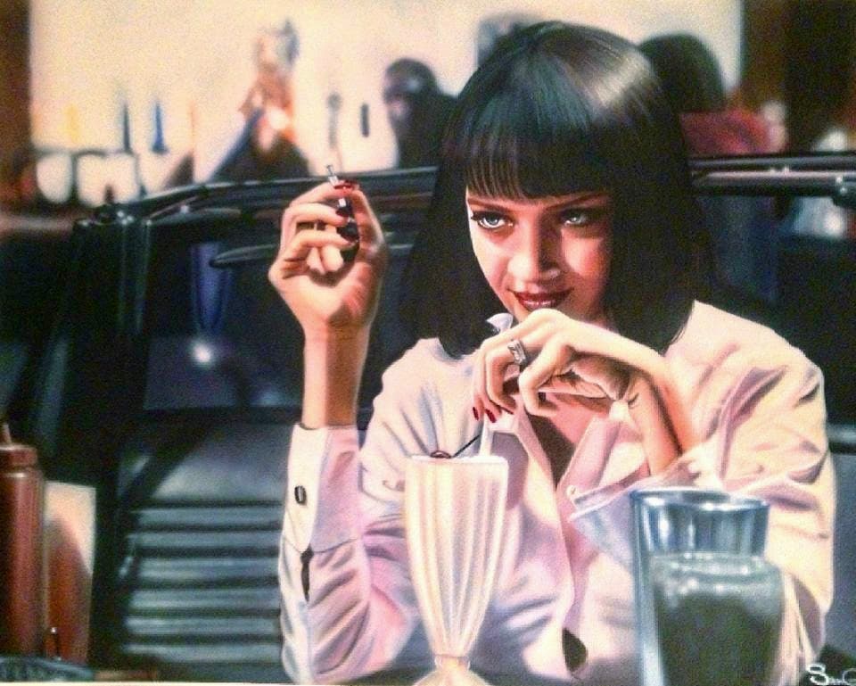 Woman with a black bob holds a cigarette, sitting at a diner with a milkshake.