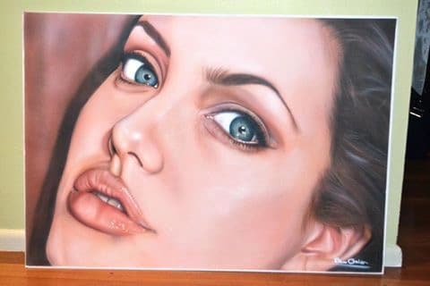 Realistic portrait painting of a woman with striking blue eyes and full, slightly parted lips.