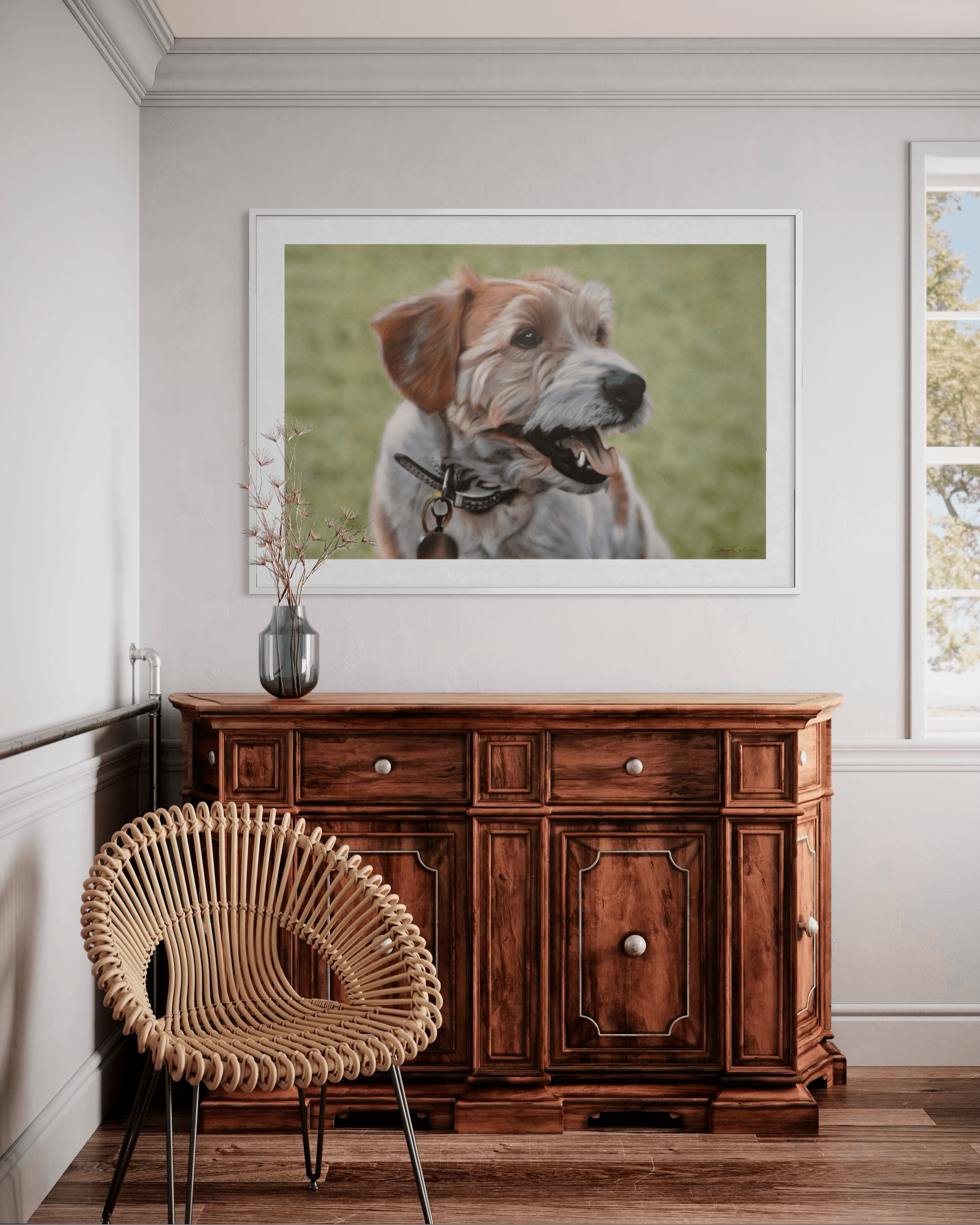 Framed portrait of a scruffy dog above a wooden sideboard and woven rattan chair.