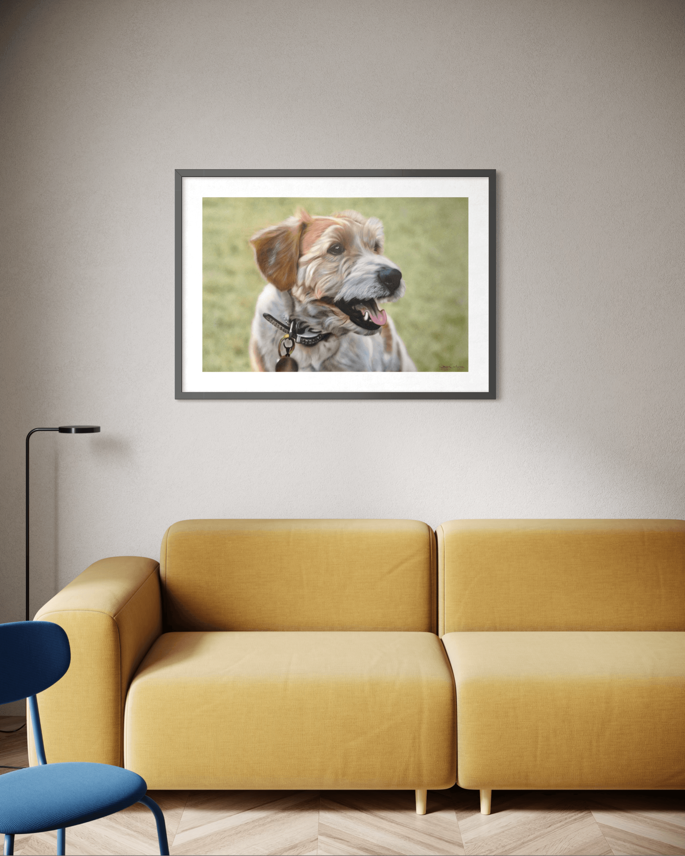 Framed scruffy dog portrait hanging on a wall above a mustard yellow sofa.