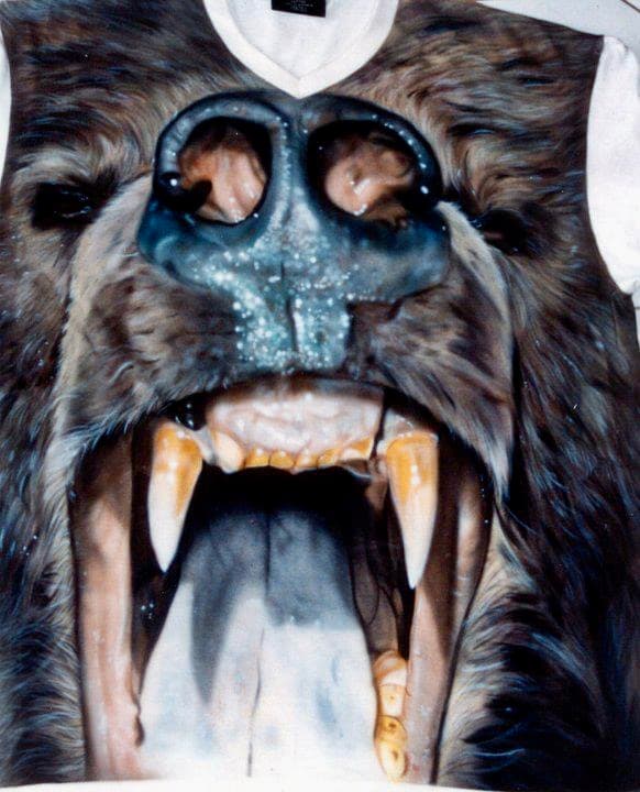 White t-shirt featuring a hyper-realistic graphic of a roaring brown bear with large fangs.